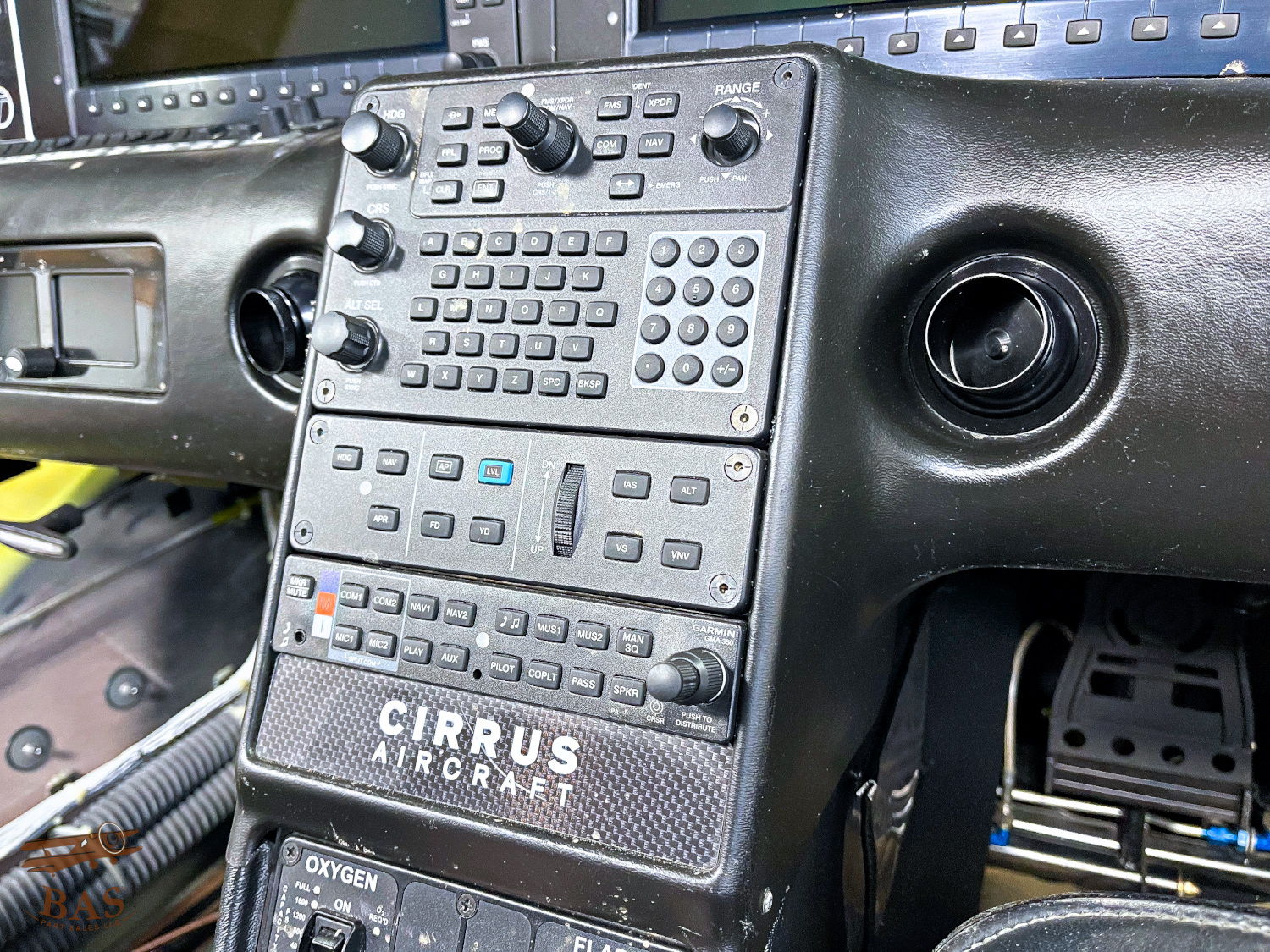 Control panel inside a Cirrus aircraft cockpit with numerous buttons and displays.