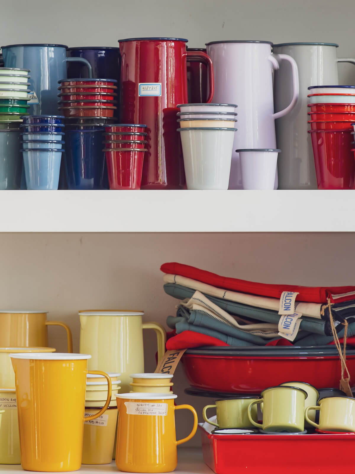 Shelves filled with different coloured Falcon Enamelware.