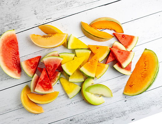 Assorted fruit slices on a wooden surface.