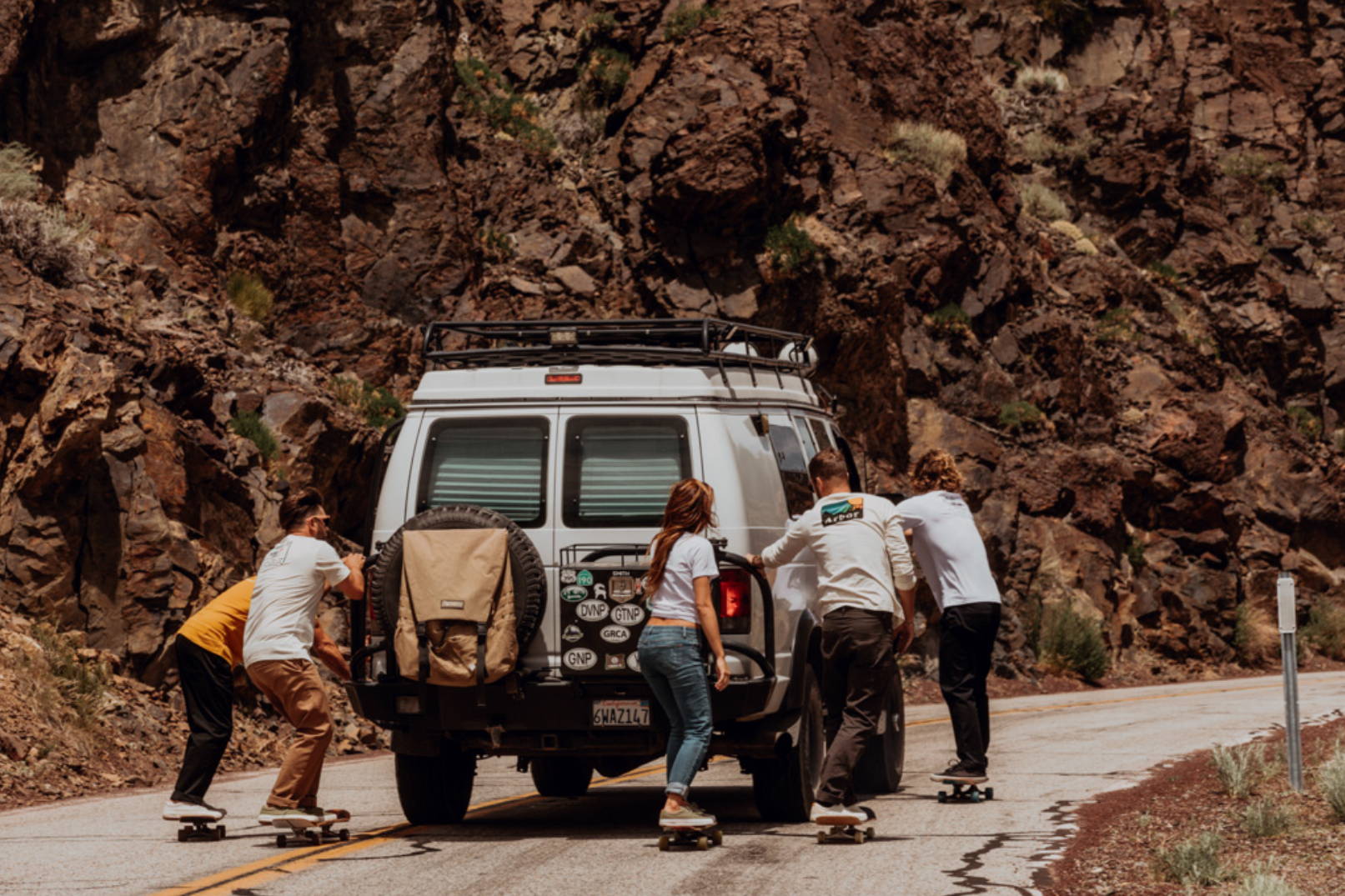 Skateboarders pulled by van