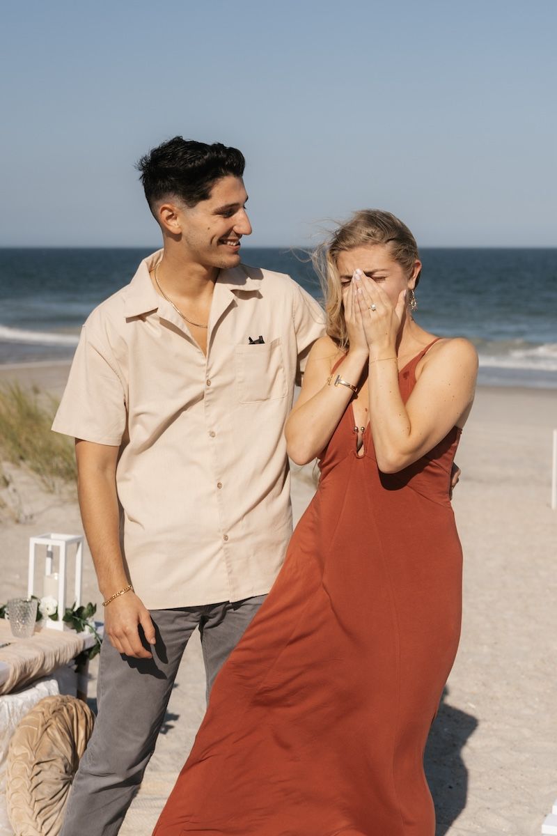 engaged couple kissing on wrightsville beach, nc