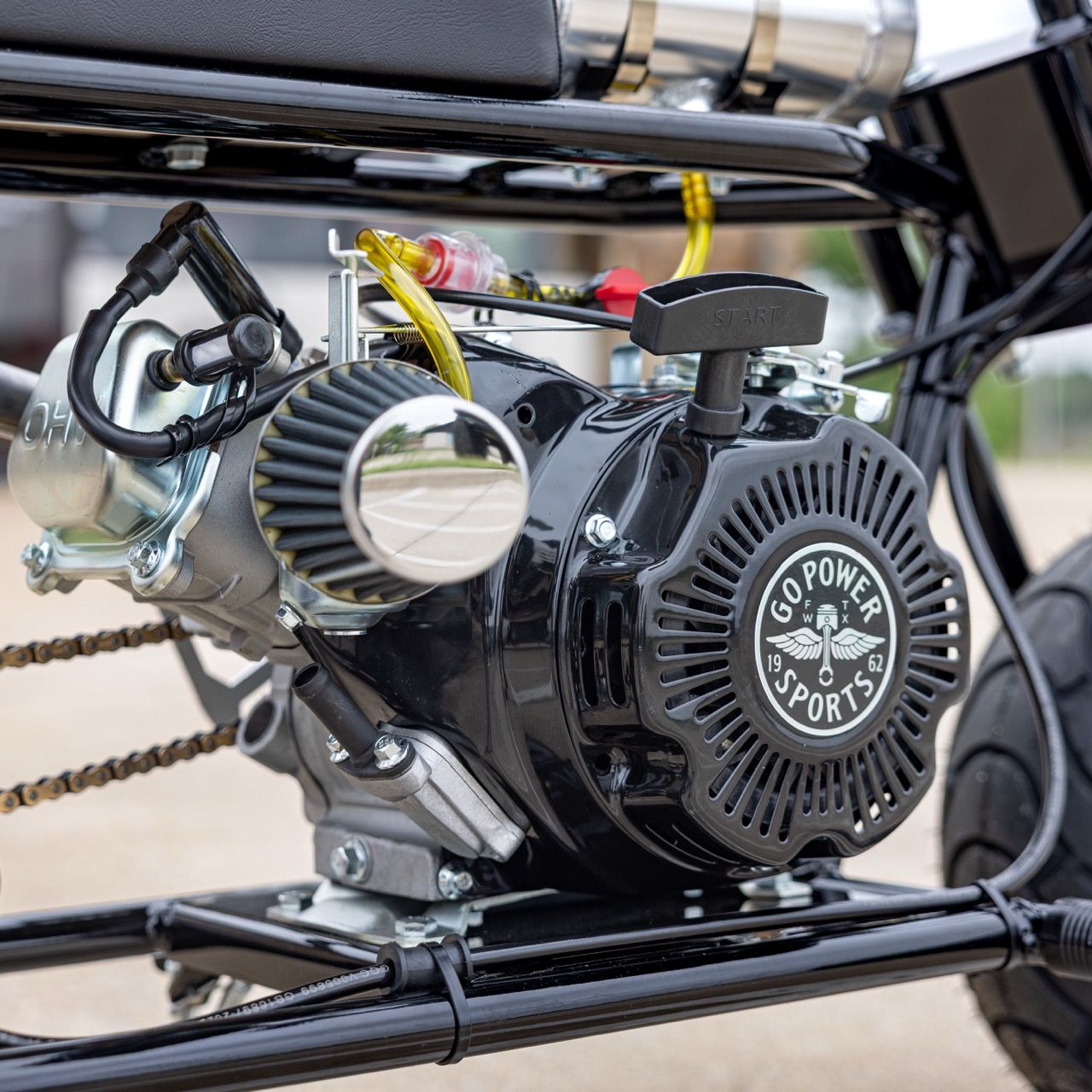 Close-up of a small engine mounted on a vehicle frame.