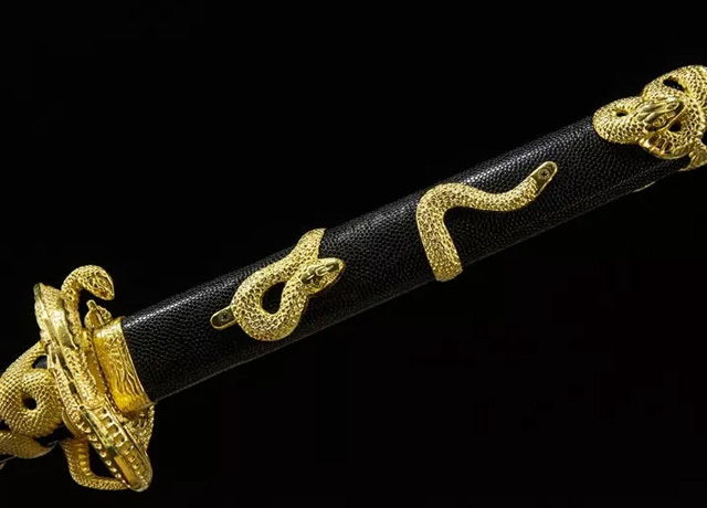 Decorative dagger with gold snake motifs on a black handle.