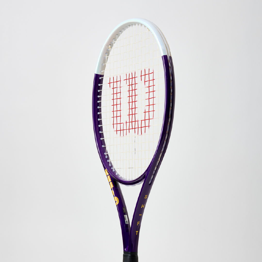 A tennis racket with a purple frame and red Wilson logo.