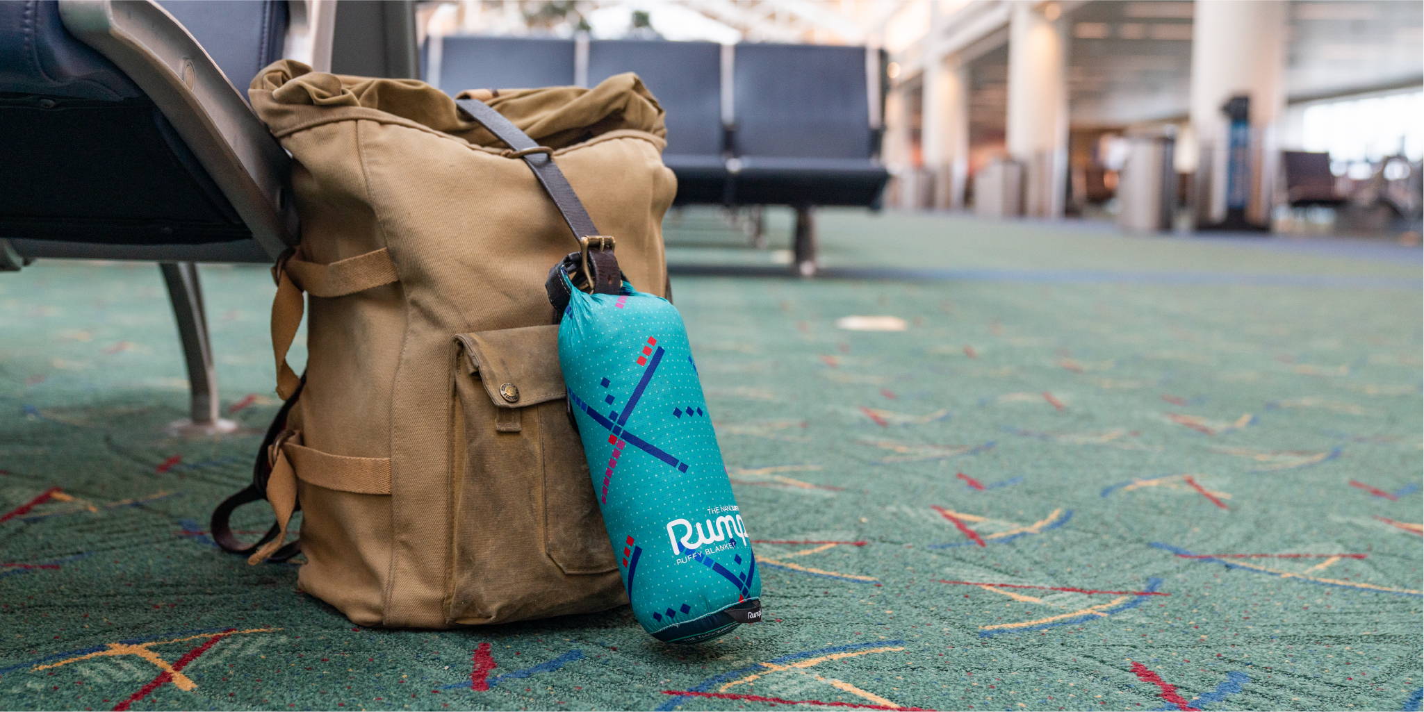 PDx Travel Blanket hooked on to backpack in PDX airport