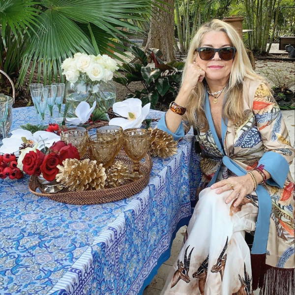 Darviny Dar wearing silk feather printed reversible jacket by her pool in Florida by Ala von Auersperg