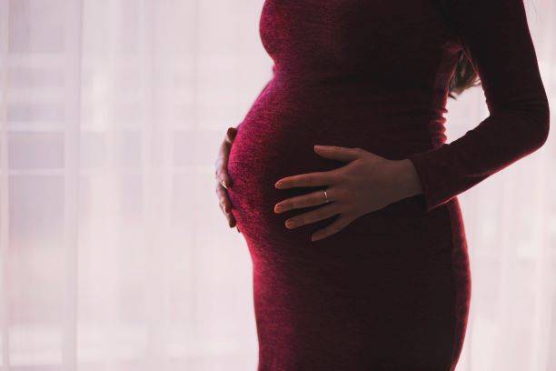 Pregnant Woman Holding Stomach