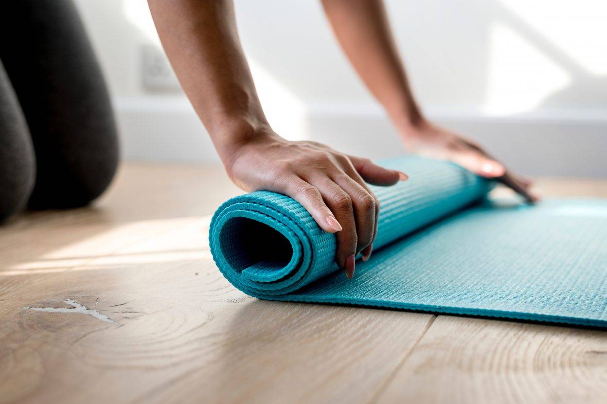 Person Rolling Yoga Mat