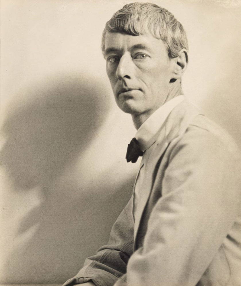 A black and white photograph of artist Norman Lindsay, taken by Harold Cazneaux in 1920