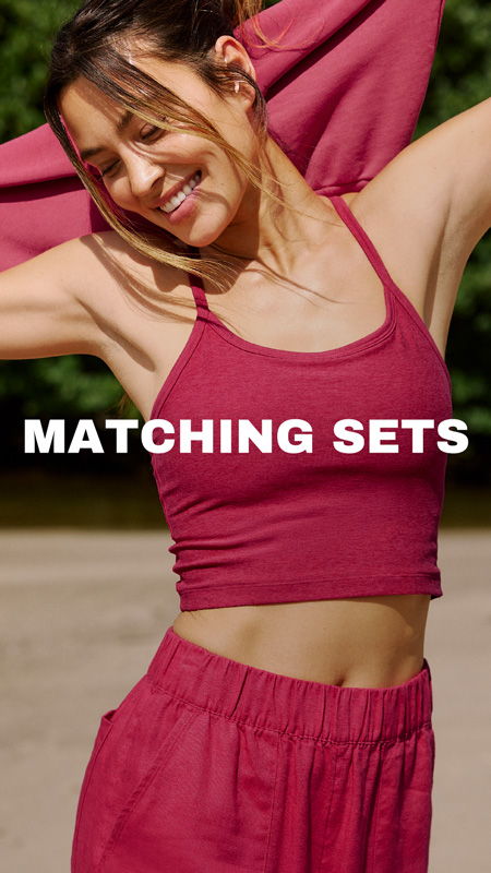 Woman smiling in matching maroon athletic set, with text 