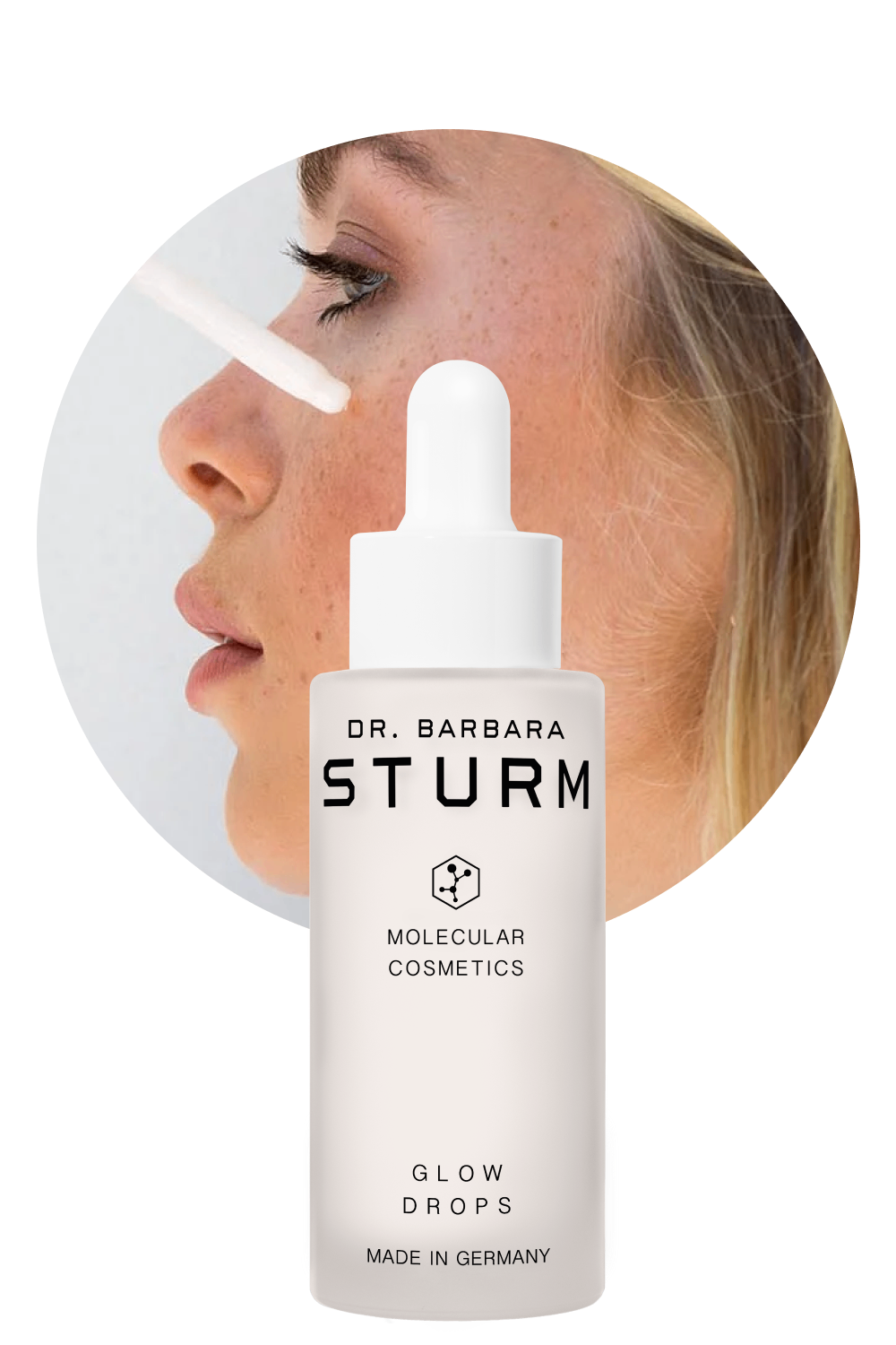 A woman applying Dr. Barbara Sturm Glow Drops on her face.