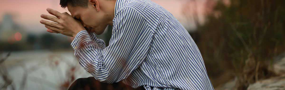 A man looking stressed out in an outdoor setting