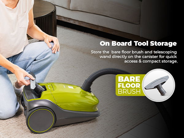 Person vacuuming with a green vacuum cleaner on a carpeted floor.