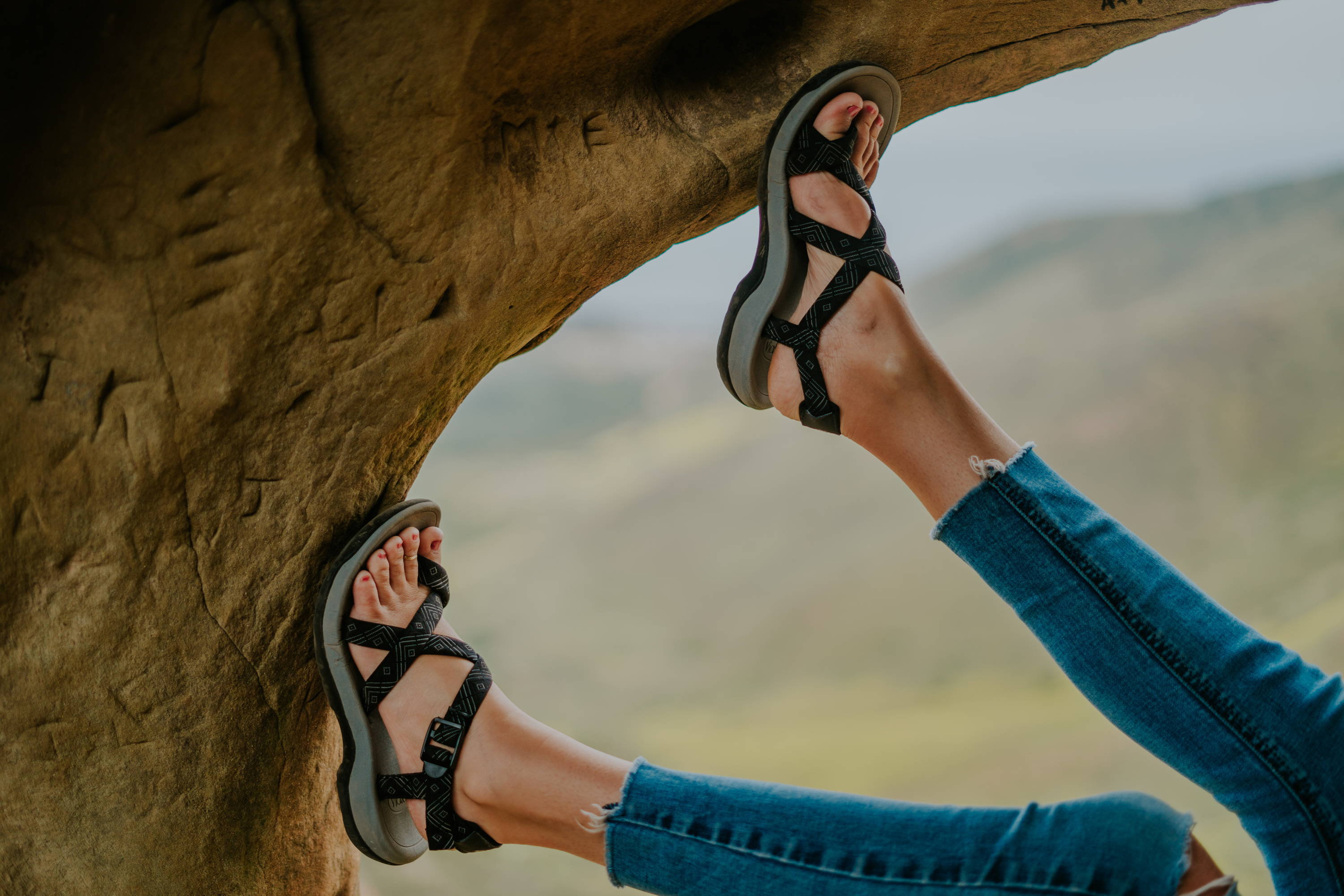 woman wearing outdoor sandals in a cave