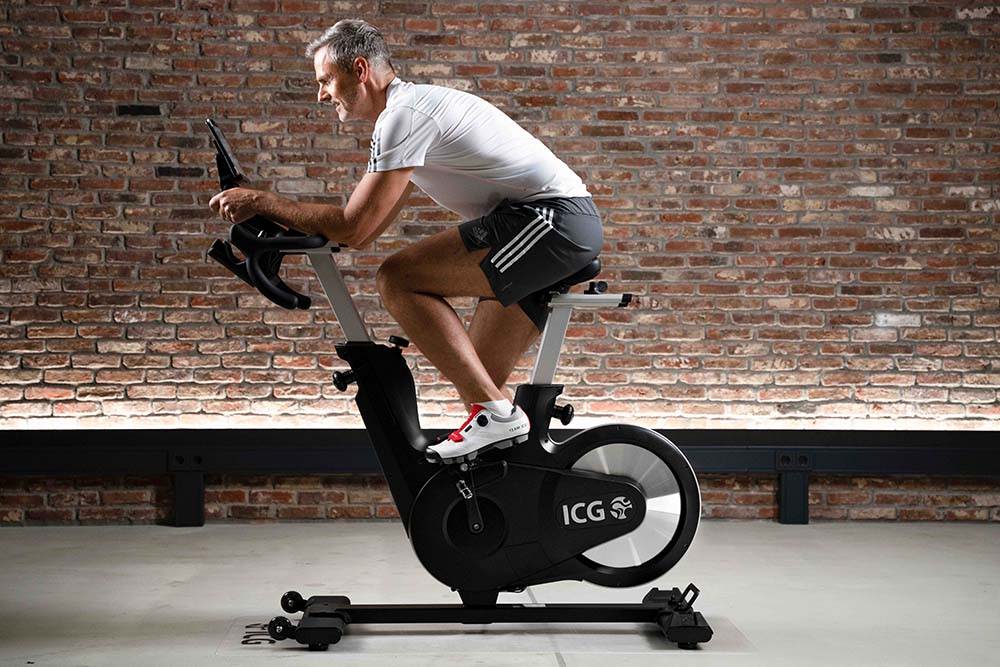 Man riding Ride CX Indoor Cycle at home