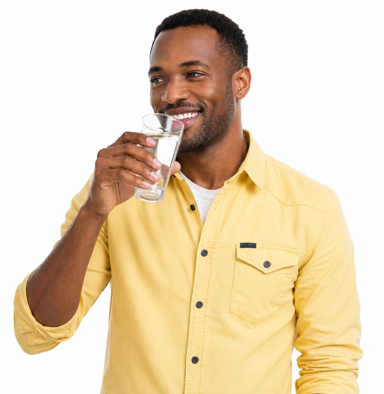 Man in a yellow shirt smiling while holding a glass of water.
