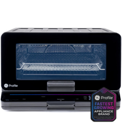 Black countertop oven with transparent door and logo badge.
