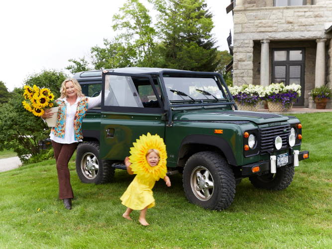 Ala Isham standing infront of a Range Rover with her granddaughter in Newport Rhode Island
