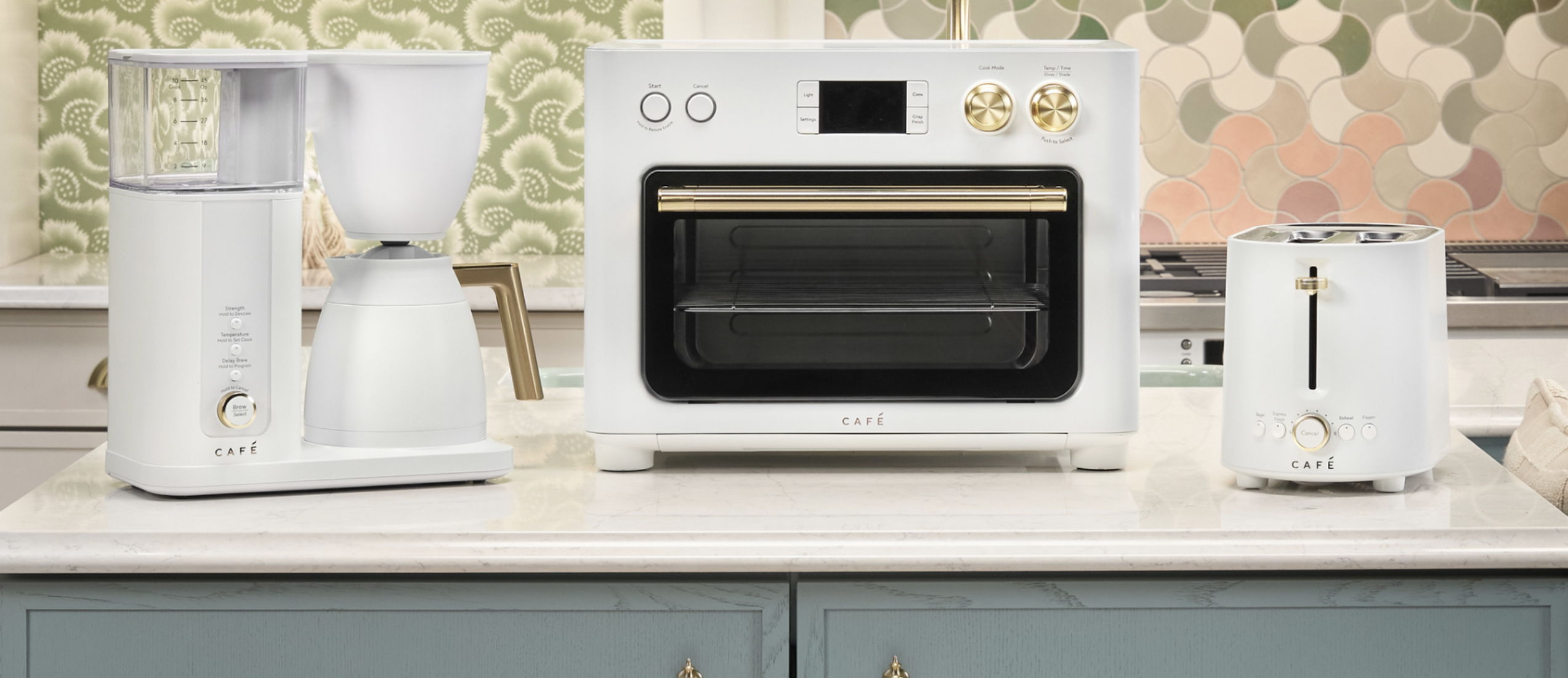 A countertop featuring a coffee maker, toaster, and toaster oven.