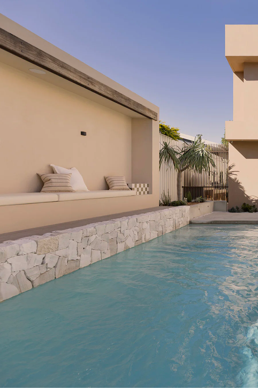 A modern house with a swimming pool and outdoor seating area.