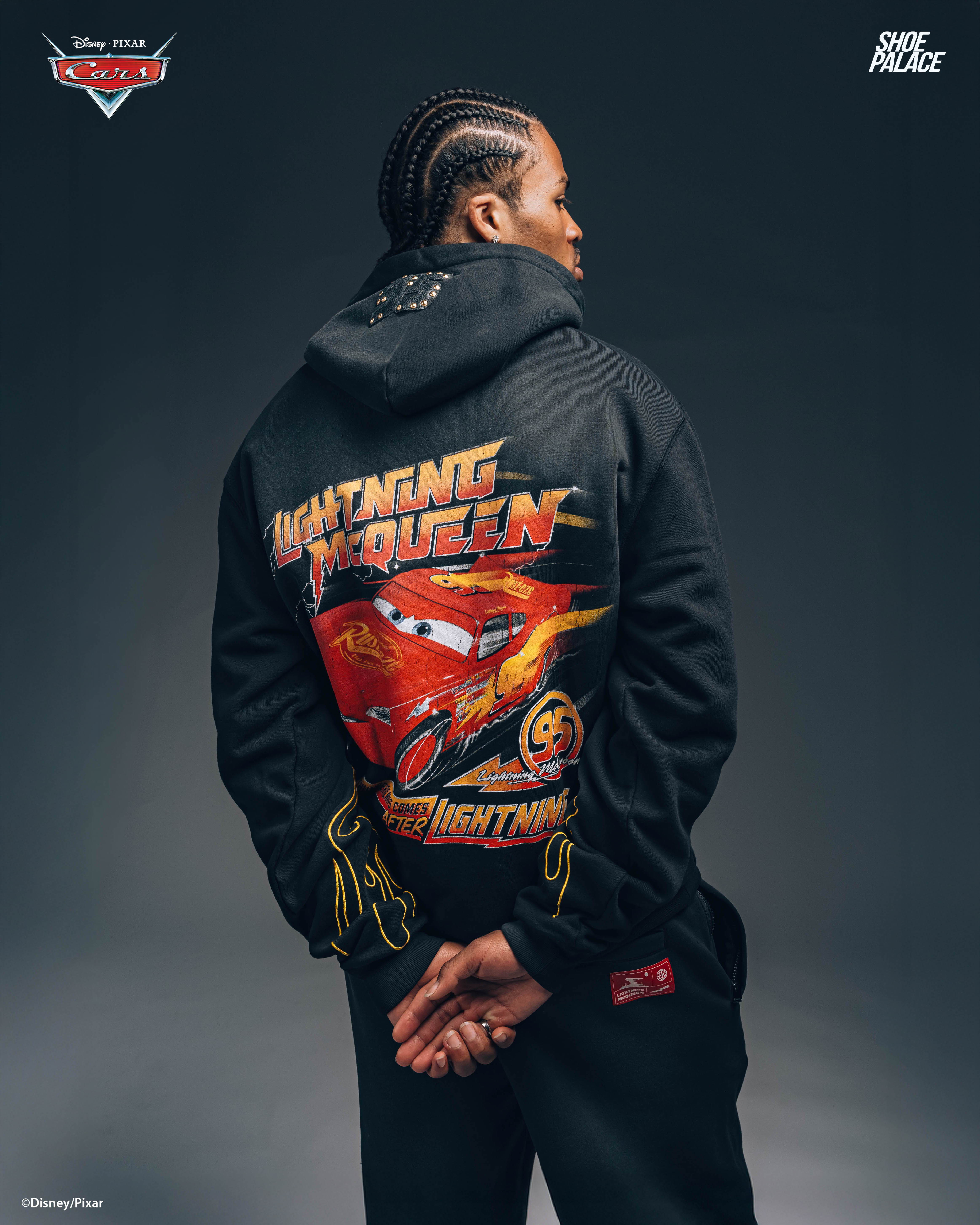 Person wearing a black hoodie with a colorful graphic on the back.