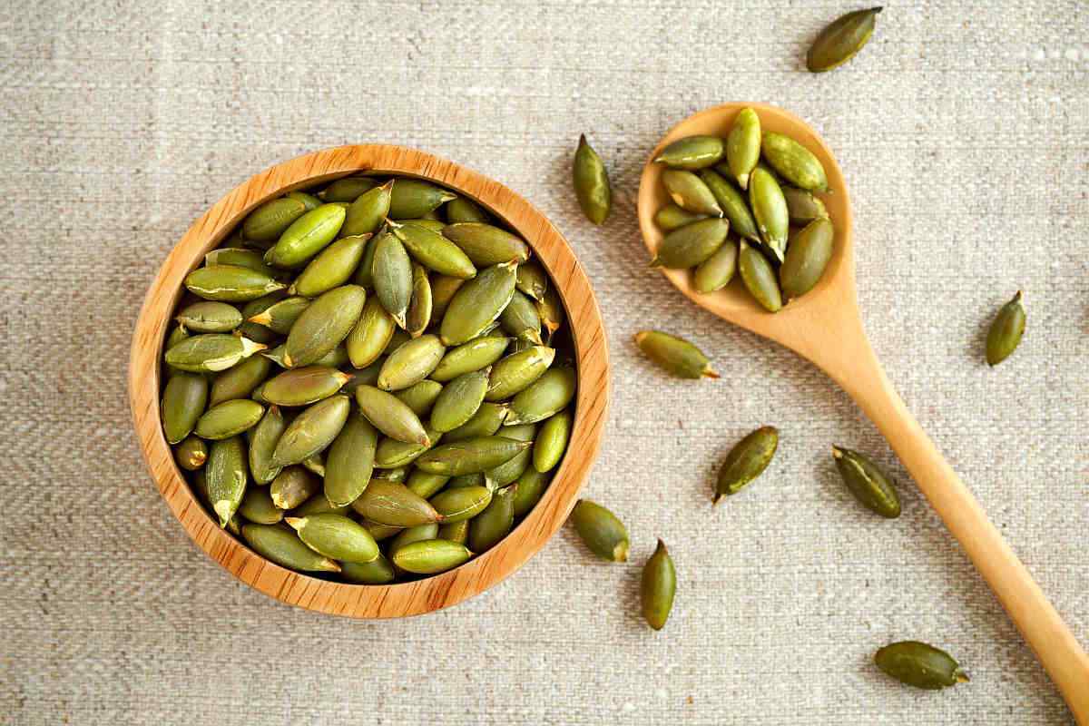 Pumpkin seeds in wooden bowl and spoon | Eat These Foods to Improve Mental Awareness | food for brain power
