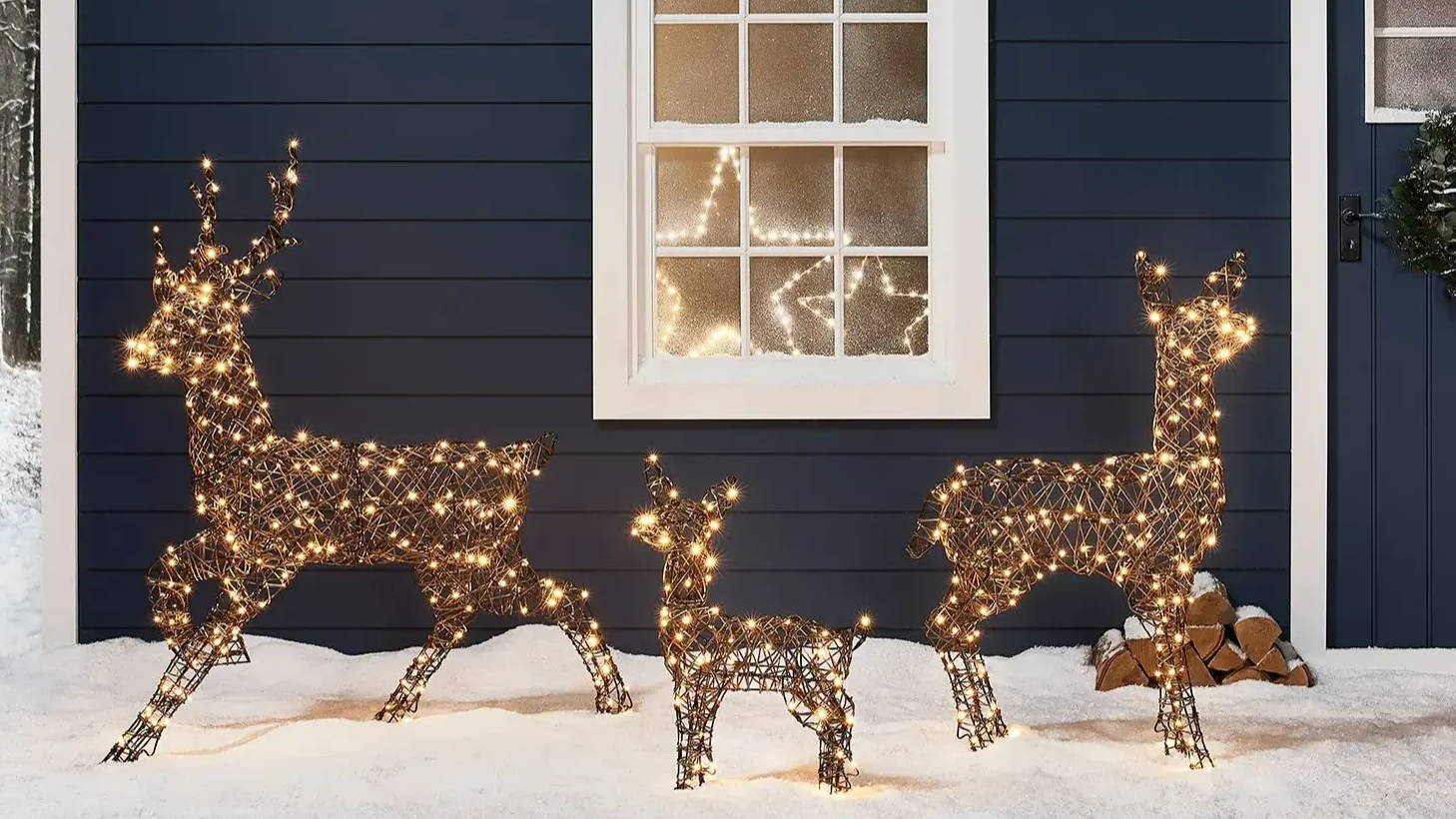 Studley light up reindeer family in a snowy outdoor setting in front of a home.