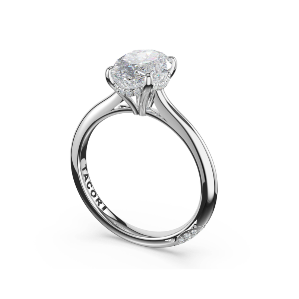 A solitaire diamond engagement ring on a polished metal band.