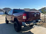 High-angle front view of maroon Ram 1500 HEMI parked in driveway with open garage