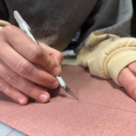 Using a precision knife to cut a pattern piece