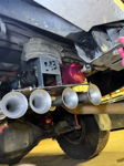 Four-trumpet train horn kit with HornBlasters compressor and pink air tank mounted under chassis