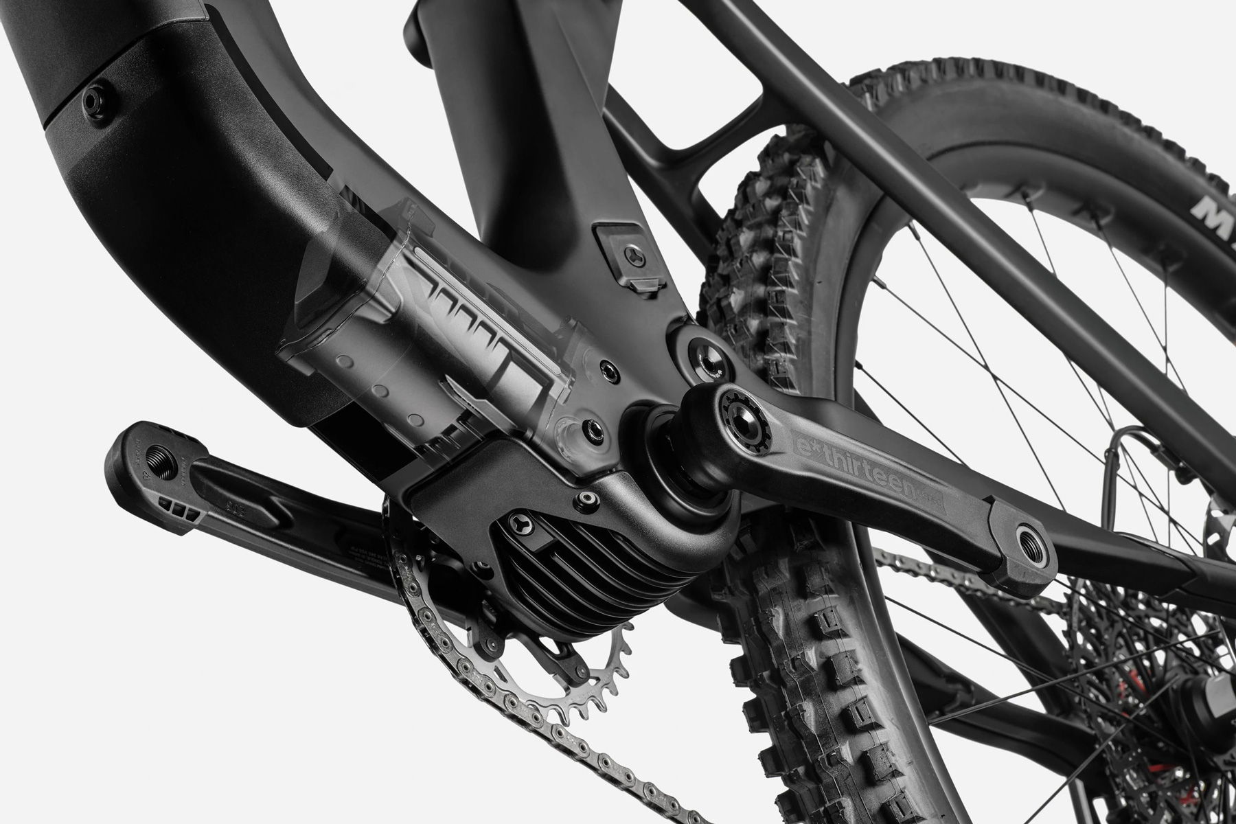 Close-up of an electric bike's drivetrain and rear wheel.