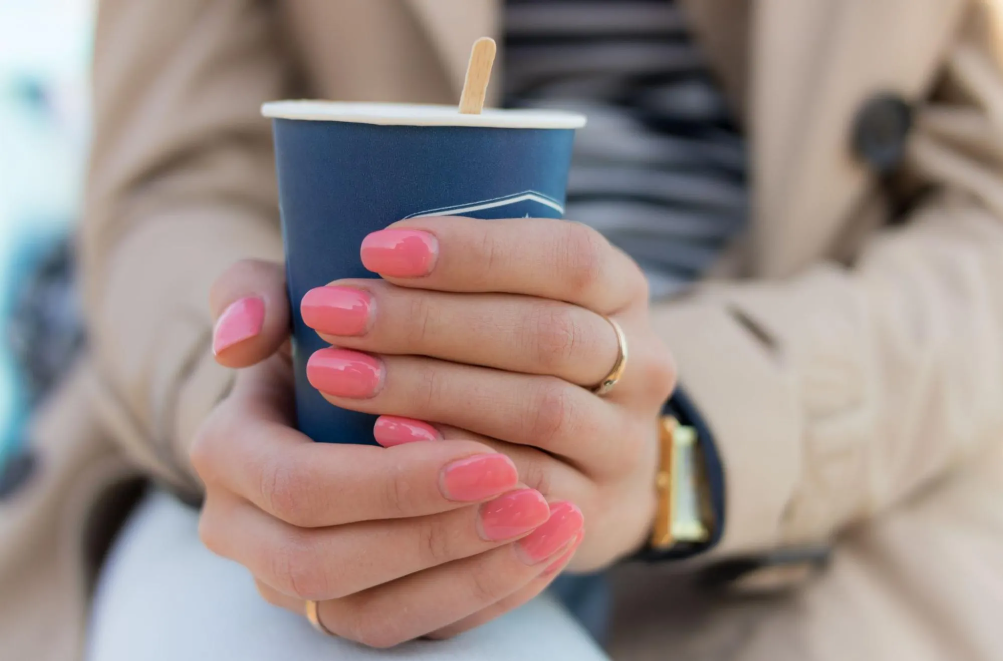 hands holding a cup of coffee