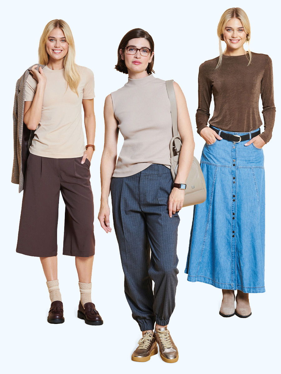 Three women in stylish outfits posing against a light background.