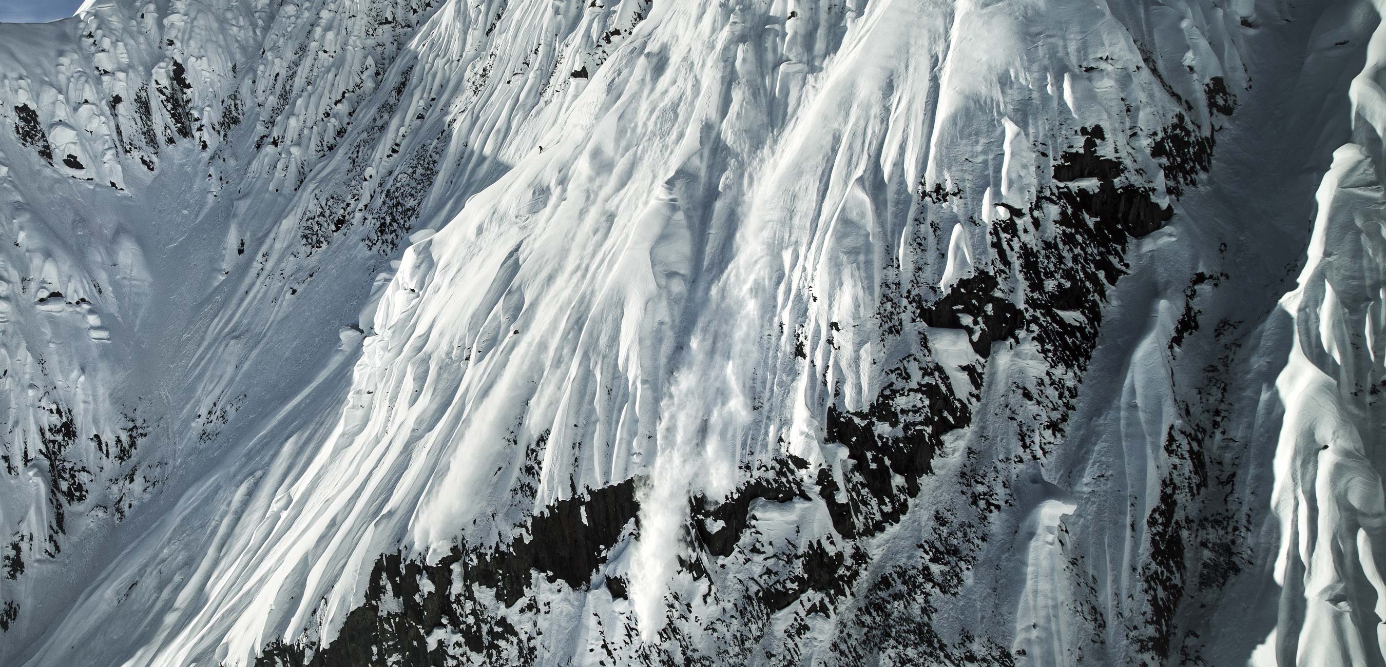 Snow-covered mountain with dramatic icy slopes and rocky outcrops.