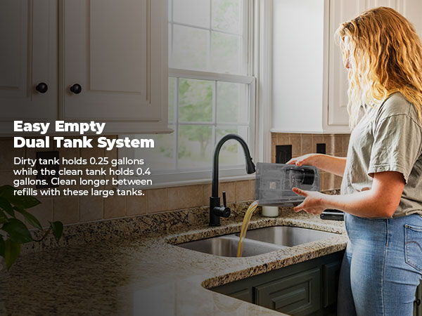 Woman using a dual tank system in a kitchen.