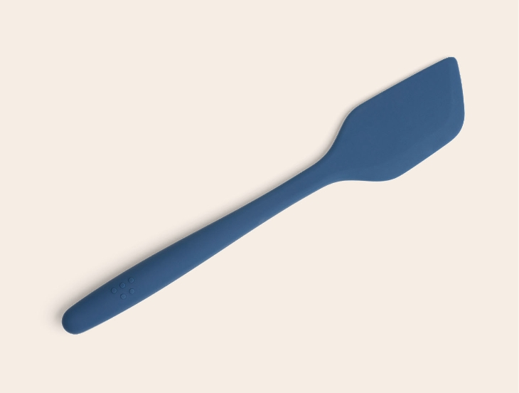 A blue Misen Silicone Spatula seen from above, with raised Misen logo visible on its ergonomic handle.