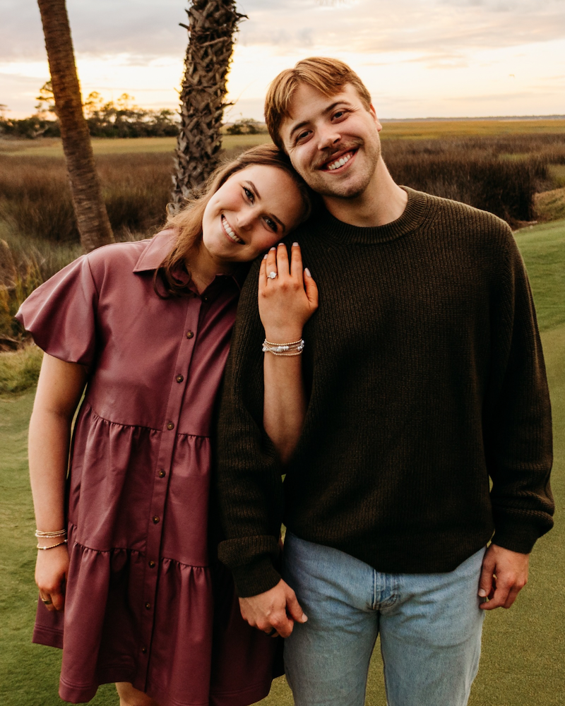 engaged couple showing engagement ring