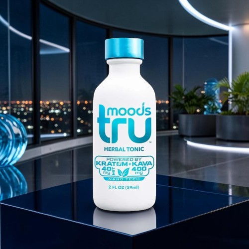 Bottle of Moods Tru herbal tonic on a reflective surface with city lights background.