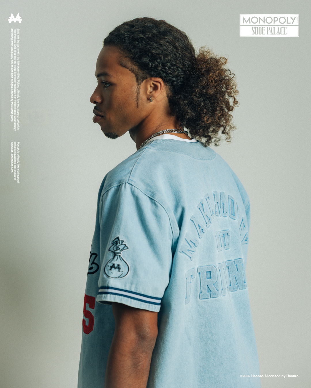 Profile of a person wearing a blue jersey with curly hair.