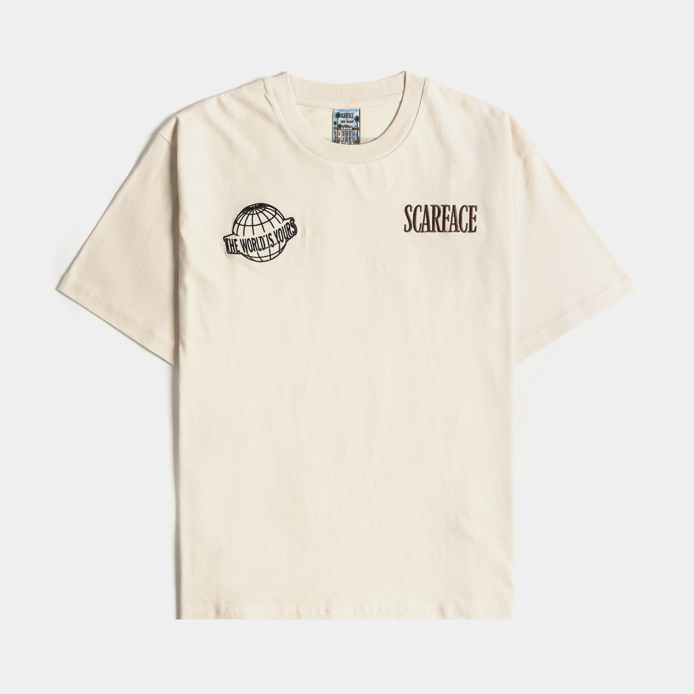 Beige t-shirt with printed designs on the front.