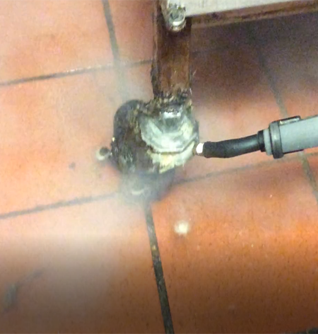 Steam cleaning grease off the wheel of a fryer