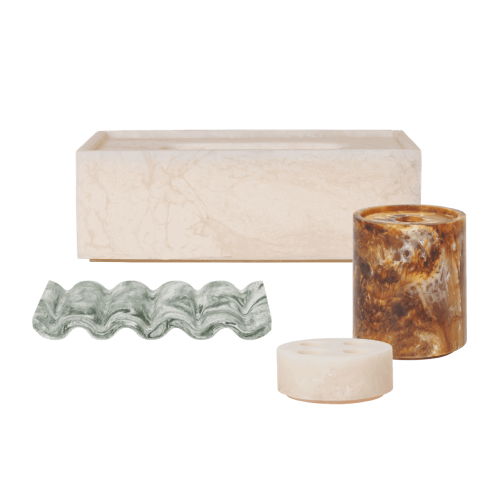 Decorative objects including a box, candle holders, and a wavy glass piece.