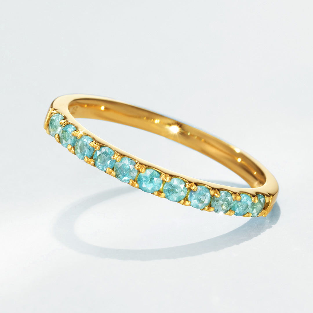 Gold ring with turquoise stones set in a delicate band.