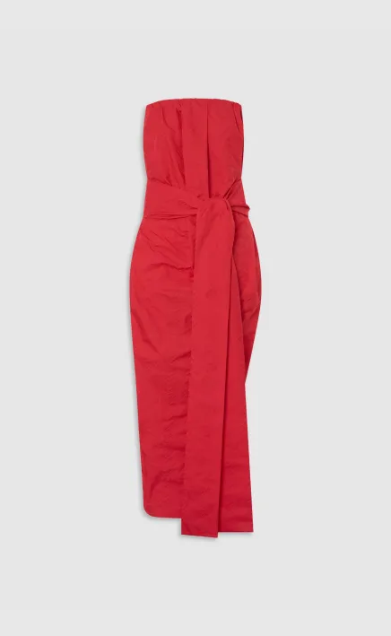 Red strapless dress with a tied waist detail.