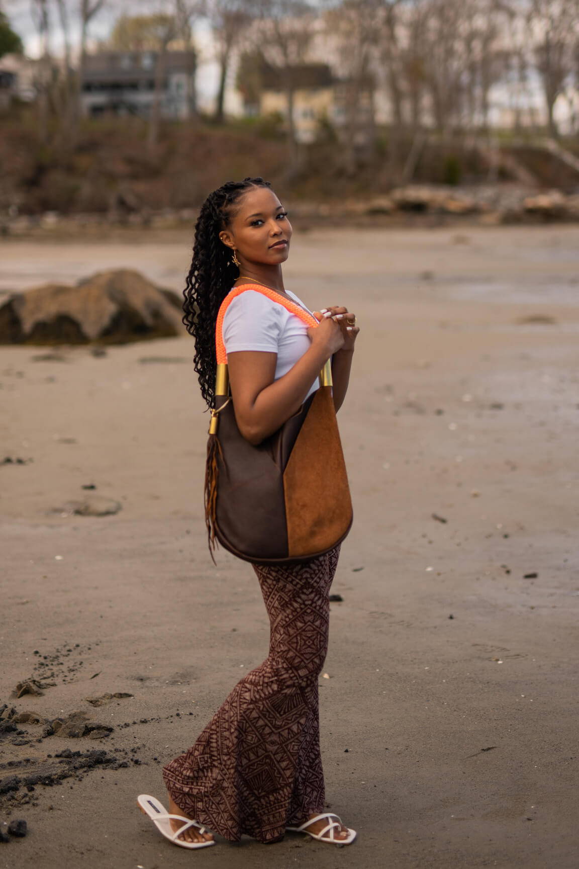 woman wearing brown leather tote bag with neon orange dock line
