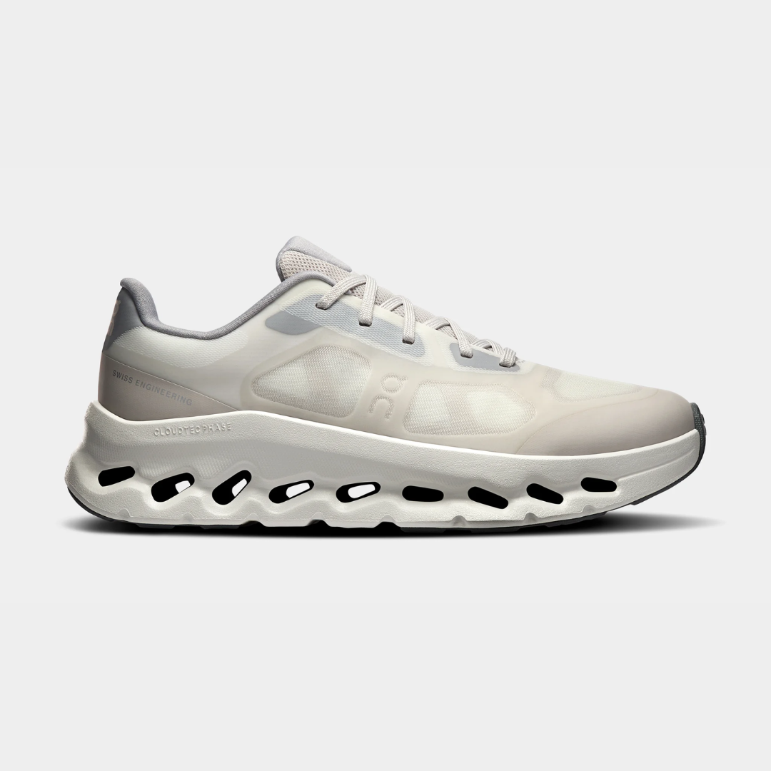 A sleek pair of white athletic shoes with a unique sole design.