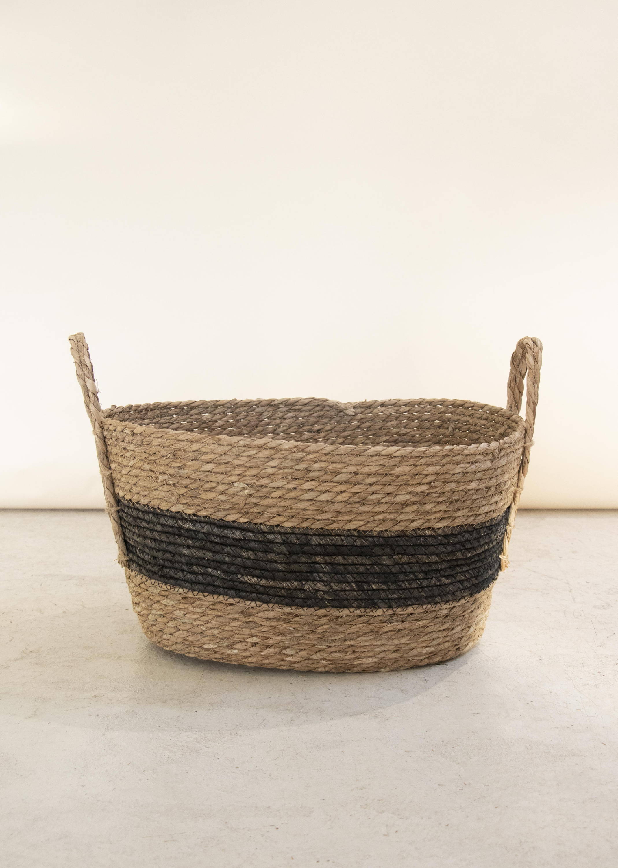 A wicker basket with stripe details