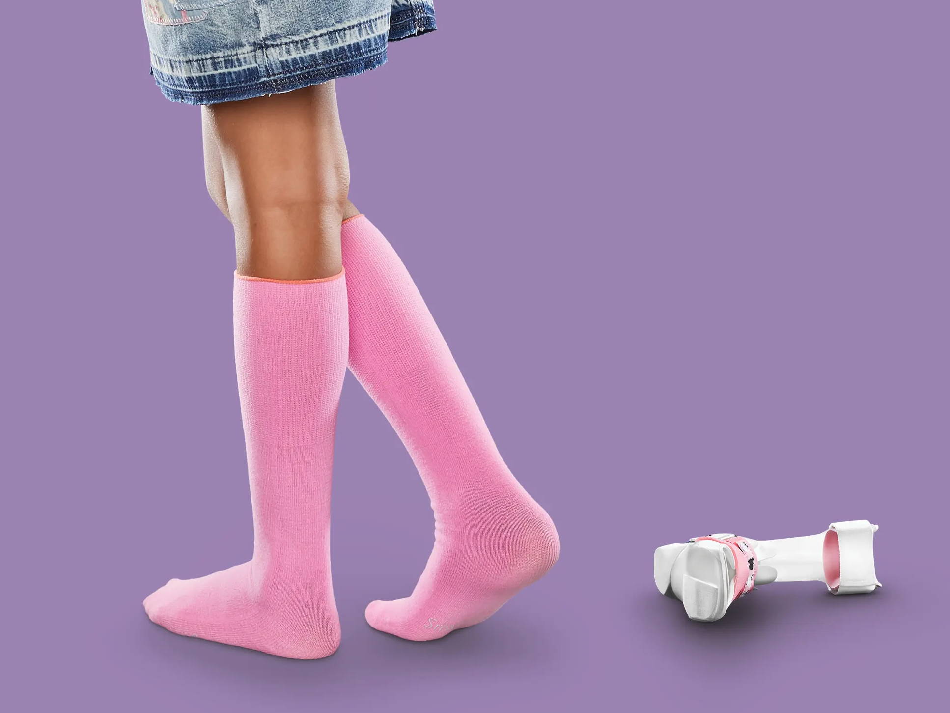 Girl wearing pink SmartKnit AFO socks, girl wearing AFO brace