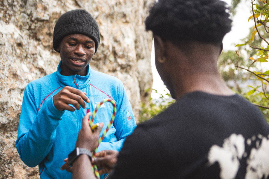 Two Malawian climbers conversing while holding a bite of the Sterling Kenya rope